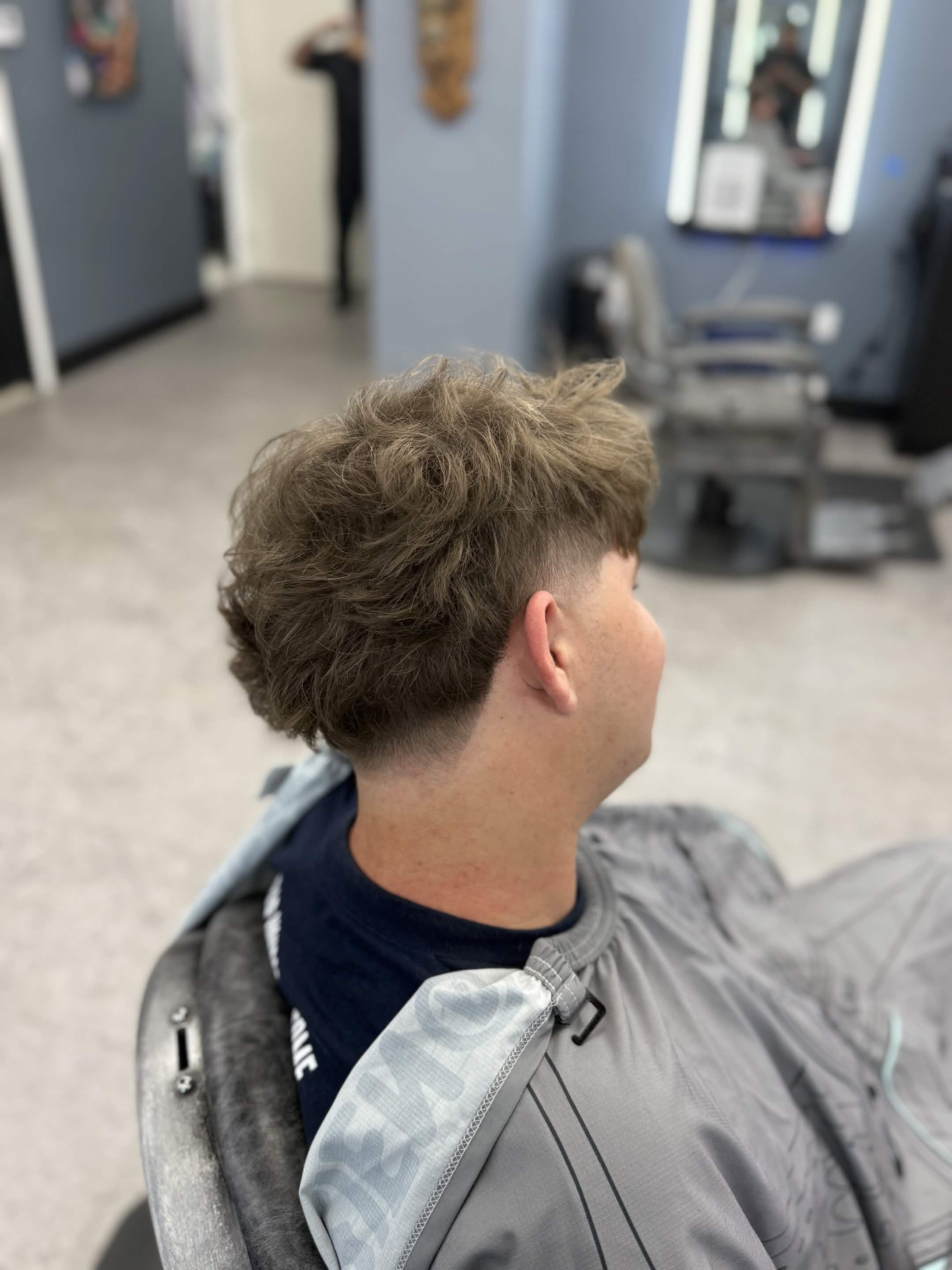 Textured haircut with clean tapered sides by Lenny