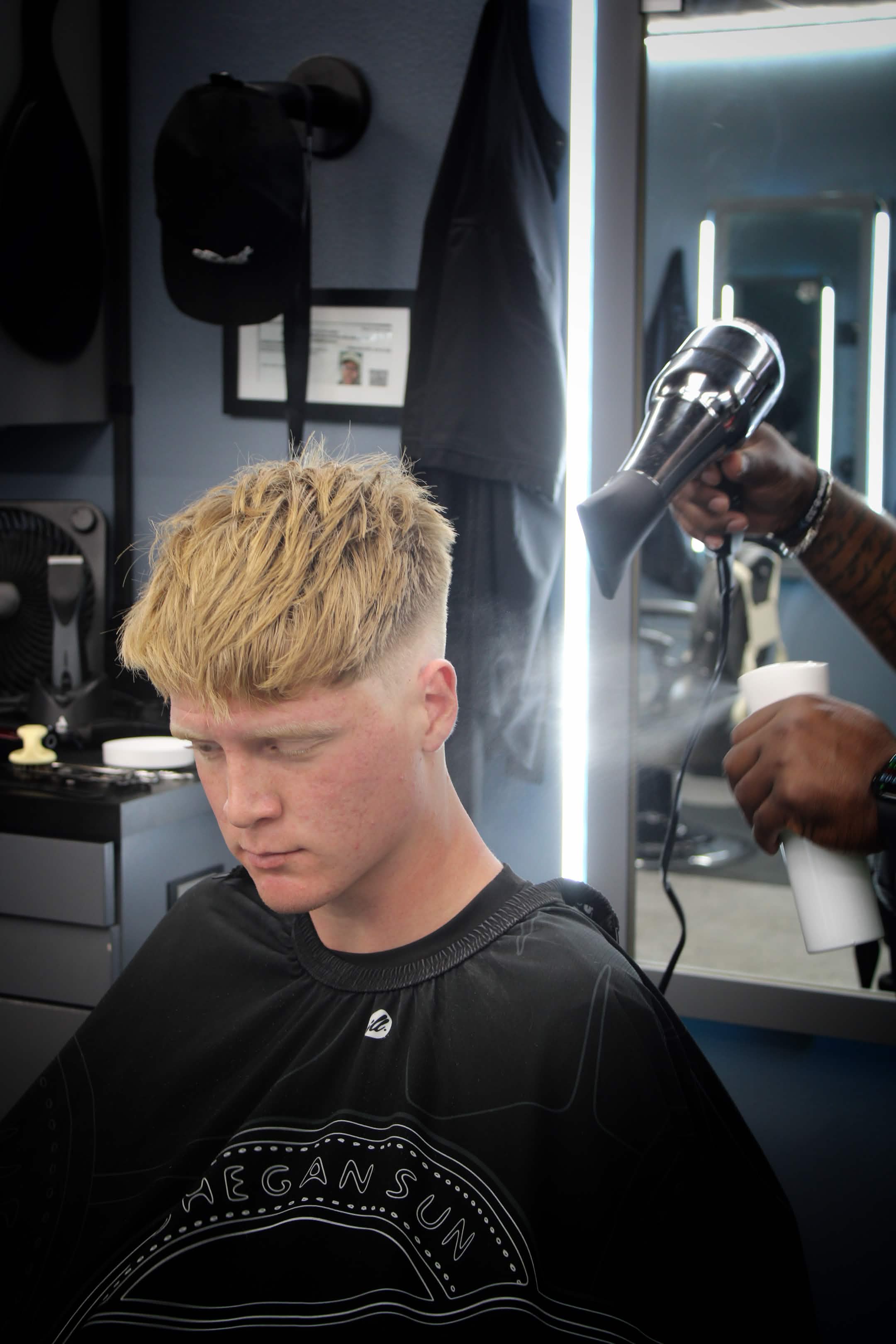 Lenny styling a fresh cut in the barber studio