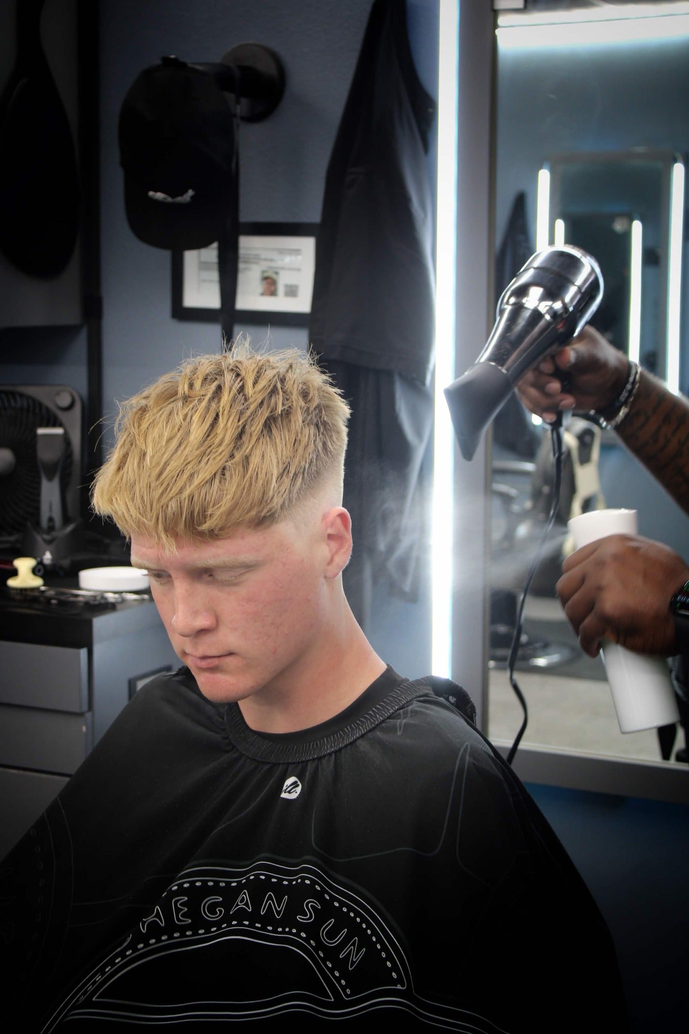 Lenny finishing a client's haircut in the barber studio